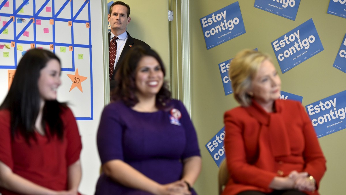 A U.S. Secret Service agent keeps an eye on Democratic presidential candidate Hillary Clinton as she meets with a group of DREAMers, at a campaign office in Las Vegas, Nevada