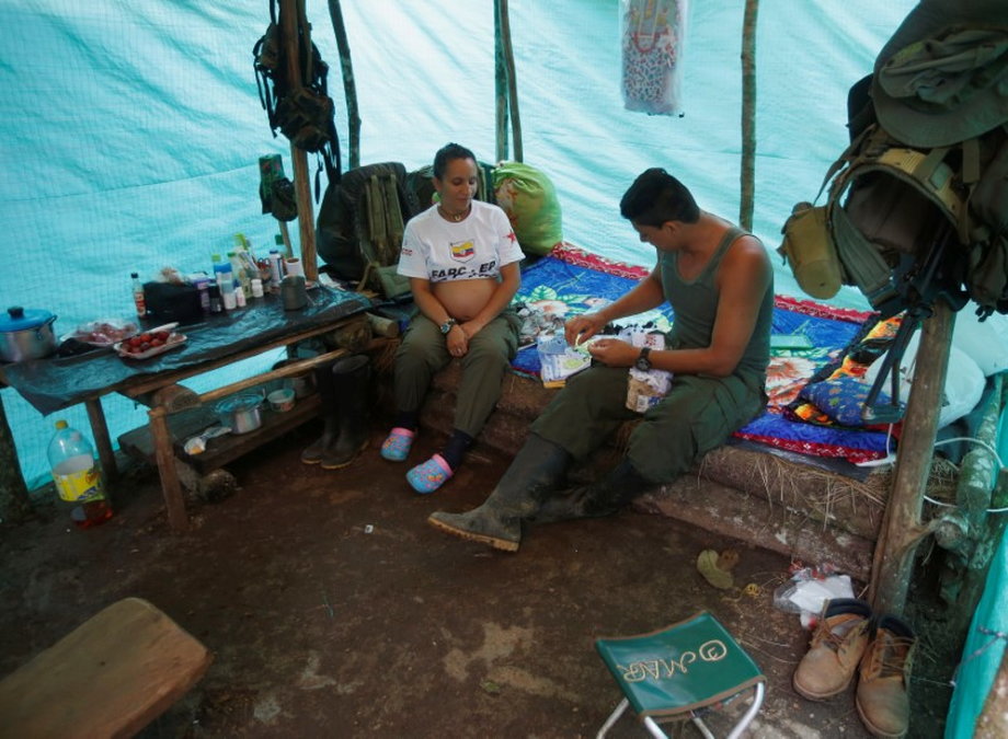 Tatiana, a FARC member, sits next to her husband.