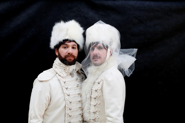 Revellers pose in Saint Mark's Square during the Venice Carnival, in Venice