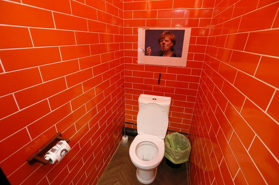 A photo of German Chancellor Angela Merkel, which customers drew on, is seen in a toilet at the "President Cafe" in Krasnoyarsk, Siberia, Russia, April 7, 2016.