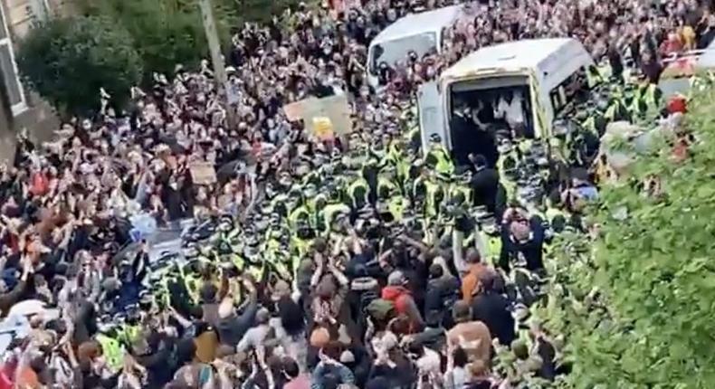 Crowds in Glasgow cheer after two men are released from an immigration enforcement van, Thursday 13 May.
