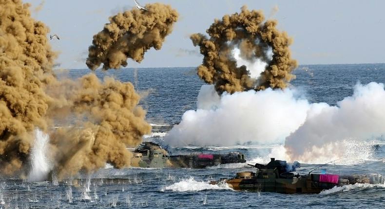 South Korean Marine amphibious assault vehicles fire smoke shells during a landing operation in the southern city of Pohang