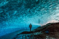 Man in glacier cave, Mendenhall Glacier, Juneau, Alaska