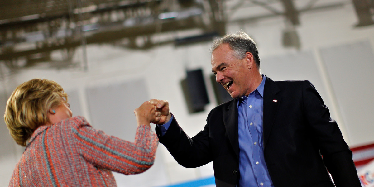 Democratic US presidential candidate Hillary Clinton and US Sen. Tim Kaine (D-Virginia) react during a campaign rally at Ernst Community Cultural Center in Annandale, Virginia, July 14, 2016.