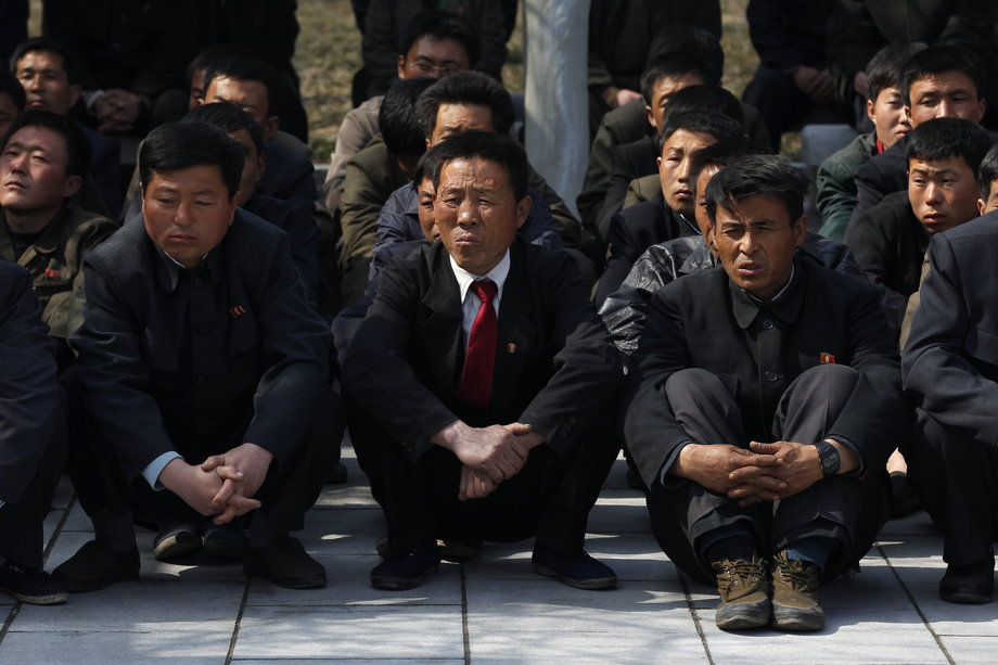 A group of North Korean visitors listen to a guide at Mangyongdae, the birthplace of North Korea founder Kim Il-sung, in Pyongyang, April 9, 2012.