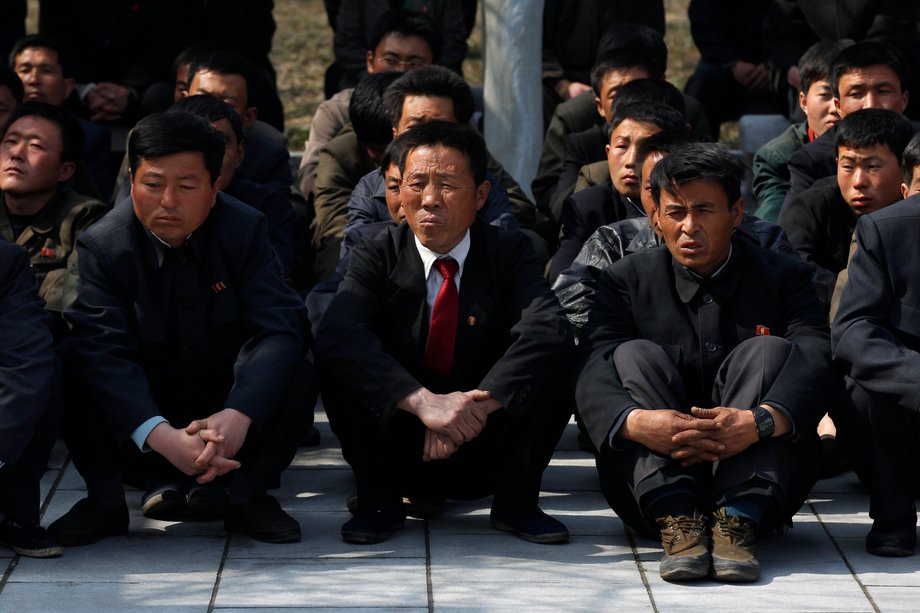 A group of North Korean visitors listen to a guide at Mangyongdae, the birthplace of North Korea founder Kim Il-sung, in Pyongyang, April 9, 2012.