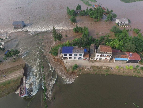 Houses are flooded as a dike breaches in Huarong County