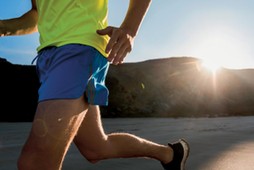 France, Crozon peninsula, young man running on the beach