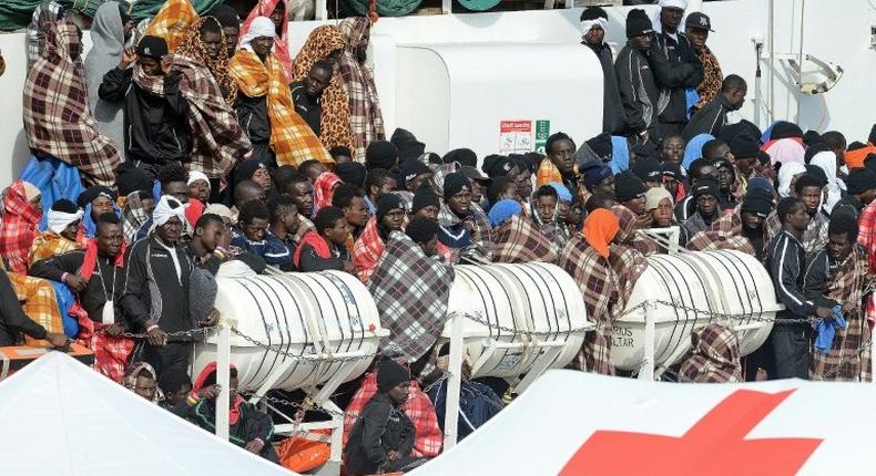 Would be immigrants wait to disembark in the port of Catania, on the island of Sicily on March 21, 2017 from the ship Aquarius following a rescue operation in the Mediterranean sea, where some 946 would be immigrants have been rescued