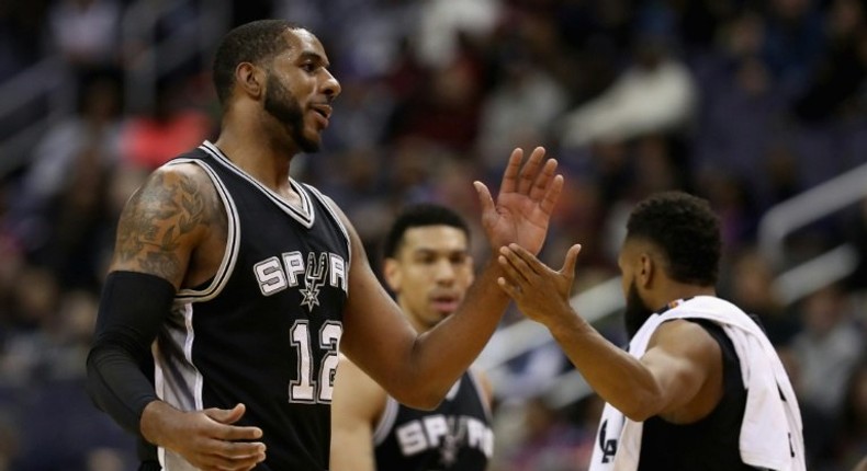 LaMarcus Aldridge of the San Antonio Spurs celebrates during a timeout against the Washington Wizards at Verizon Center on November 26, 2016