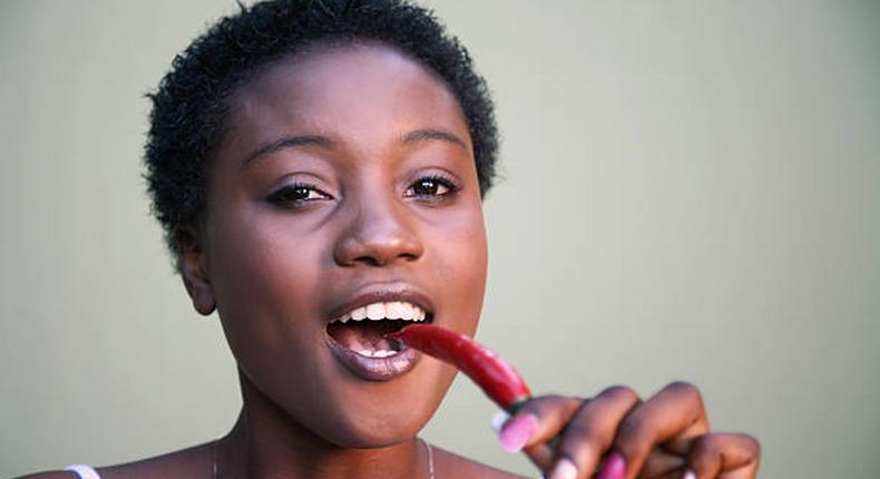 Woman eating hot peppers