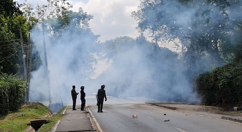 Police look on after launching tear gas