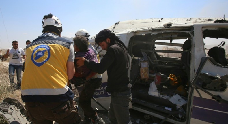 Syrian rescuers at the scene of an air strike that hit an ambulance in the town of Maaret al-Numan in northwest Syria on June 20