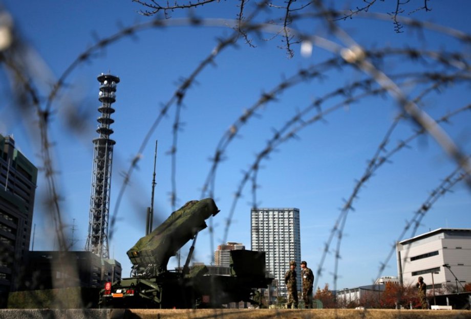 Members of the Japan Self-Defence Forces stand guard near Patriot Advanced Capability-3 (PAC-3) land-to-air missiles, deployed at the Defense Ministry in Tokyo, Japan, December 7, 2012.