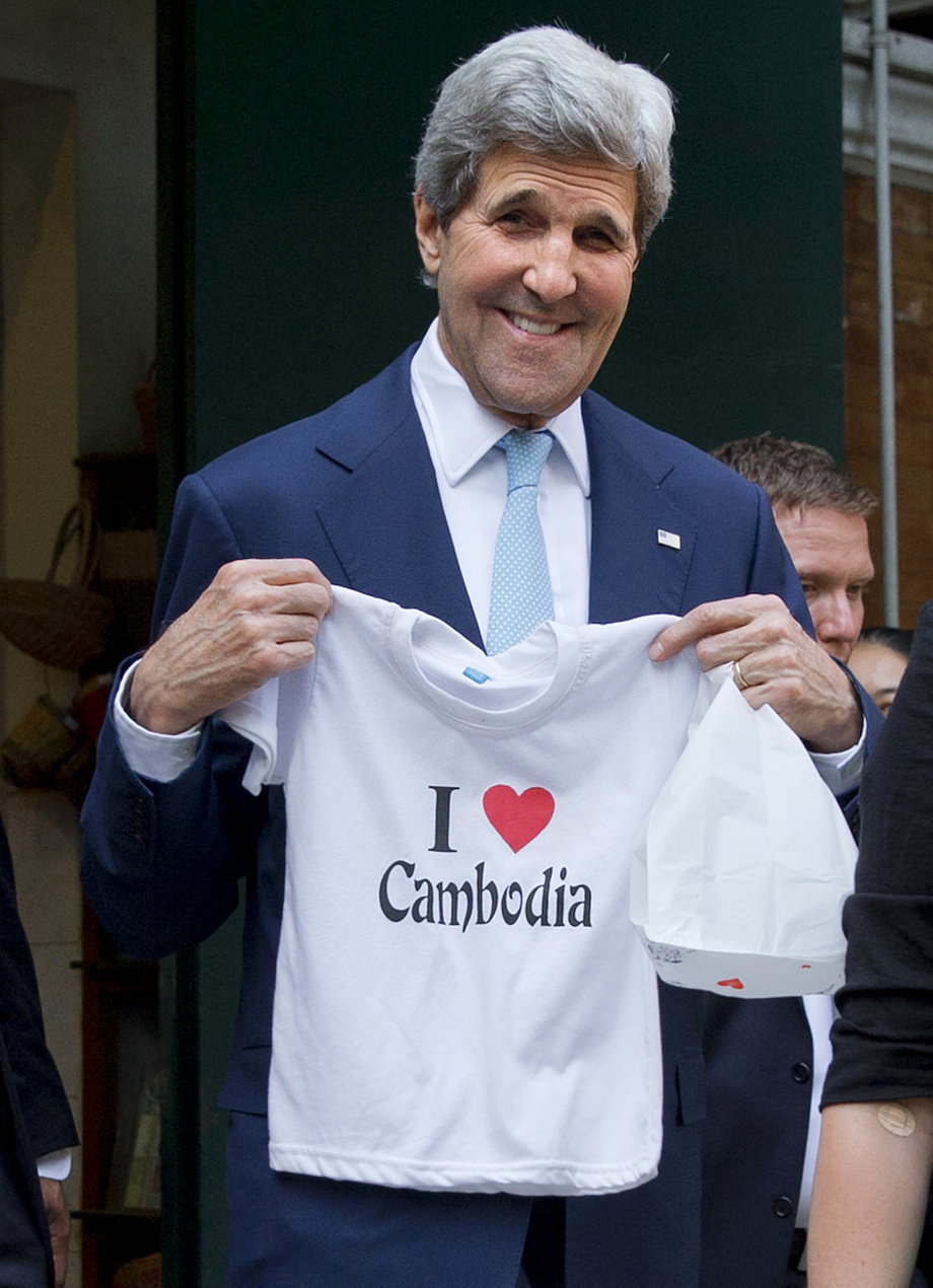 CAMBODIA: Kerry holds a "I love Cambodia" t-shirt that he bought for his grandchild as he walks out of the souvenir shop in Phnom Penh on January 26, 2016