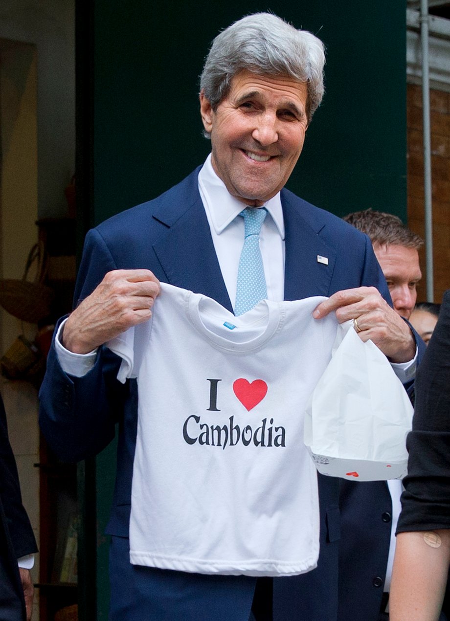 CAMBODIA: Kerry holds a "I love Cambodia" t-shirt that he bought for his grandchild as he walks out of the souvenir shop in Phnom Penh on January 26, 2016