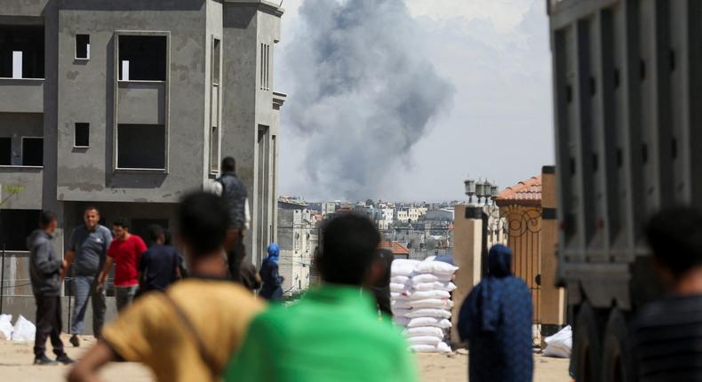 Palestinians watch smoke rise in Rafah. Israel has warned civilians to evacuate the eastern part of the city.Reuters