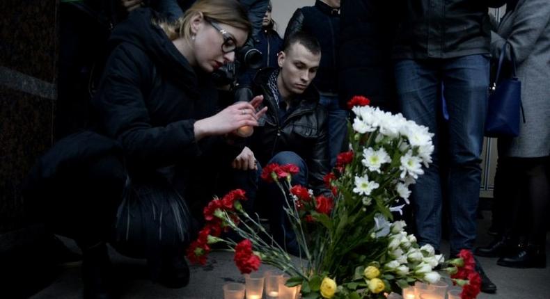 People place flowers and lit candles in memory of victims of the blast in the Saint Petersburg metro outside Sennaya Square station on April 3, 2017