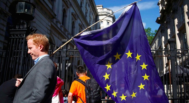 A man carries a EU flag, after Britain voted to leave the European Union, outside Downing Street in London, Britain June 24, 2016.