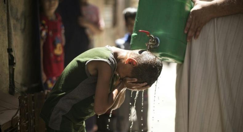 Israel is to supply millions of cubic metres of water to Palestinians including in the Gaza Strip, where a Palestinian boy is seen here cooling off with water from a jerrycan during a heatwave on July 2, 2017