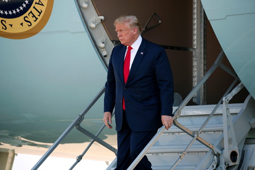 U.S. President Donald Trump walks from Air Force One as he arrives in Dallas, Texas