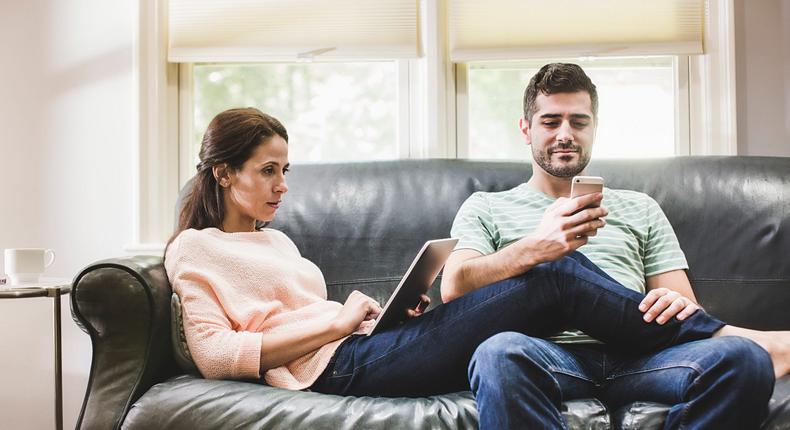 couple at home using devices