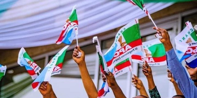 APC members holding party flag (PeoplesGazette)