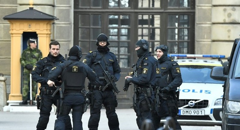 Police stand outside Stockholm Castle after a truck crashed into the Ahlens department store at Drottninggatan in central Stockholm, April 7, 2017