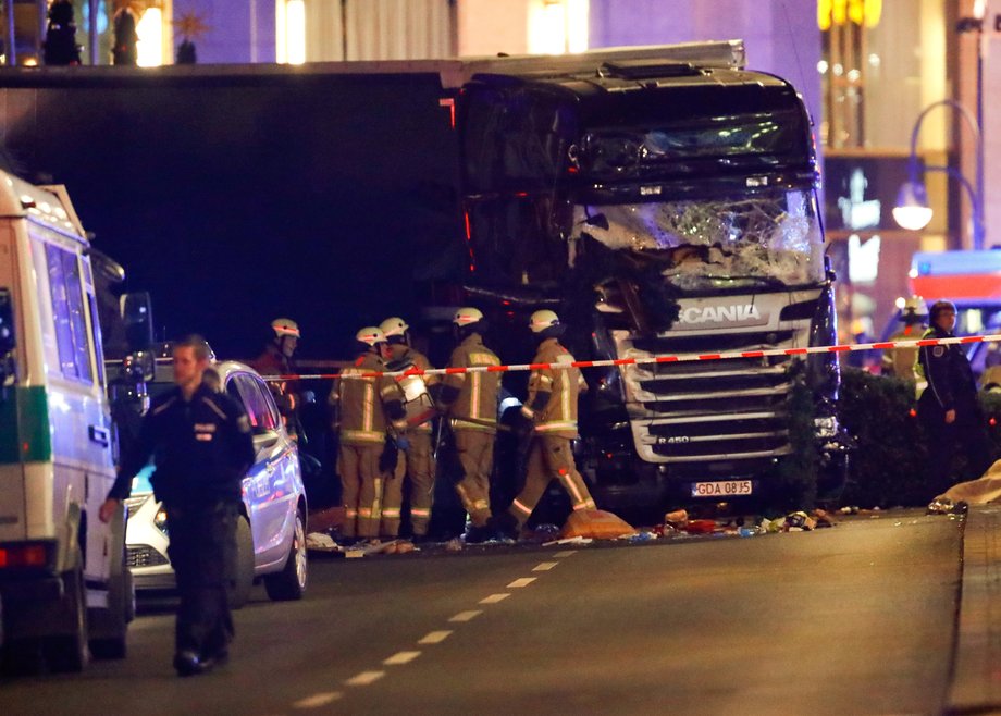 Police officers and emergency workers next to the truck on Monday night.