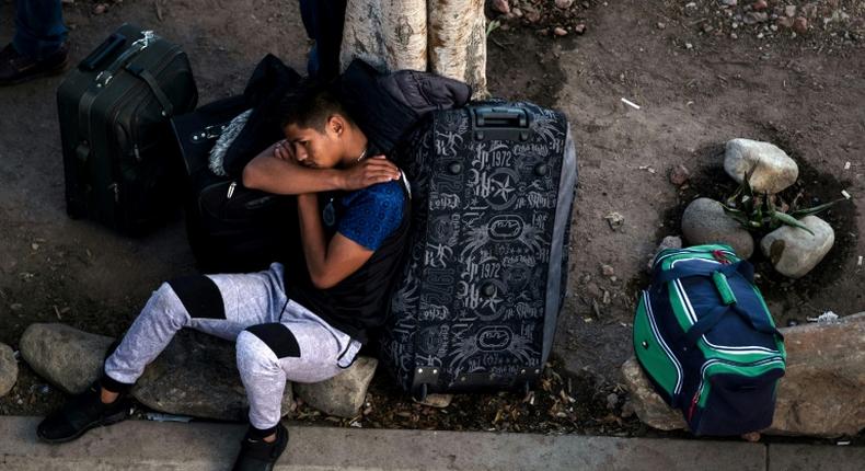 An asylum seeker rests outside El Chaparral port of entry while he waits for his turn to present himself to US border authorities to request asylum, in Tijuana, Mexico, on April 9, 2019