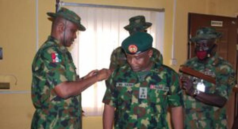 Brig-Gen. Usman Bello, outgoing Brigade commander, Nigerian Army 4, Brigade (l), decorating the Brig-Gen. Musa Sadiq, new Brigade Commander with the Brigade insignia on Tuesday in Benin