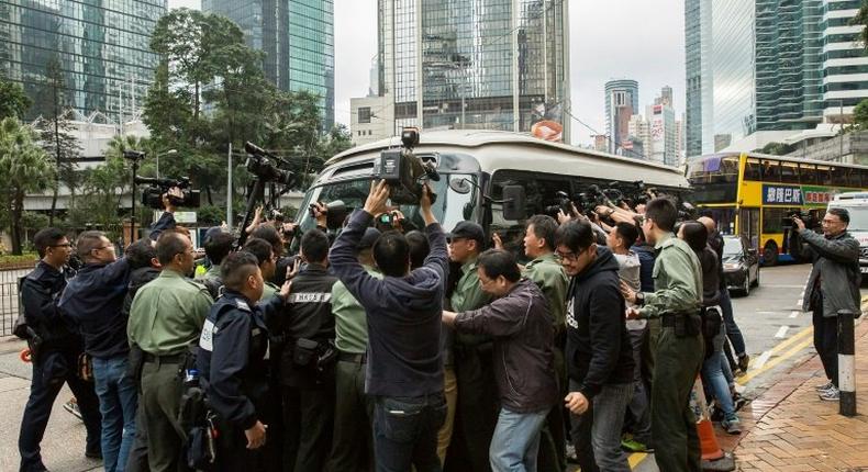 A media scrum greets former Hong Kong leader Donald Tsang as he arrives at court to hear his 20-month prison sentence for misconduct in office