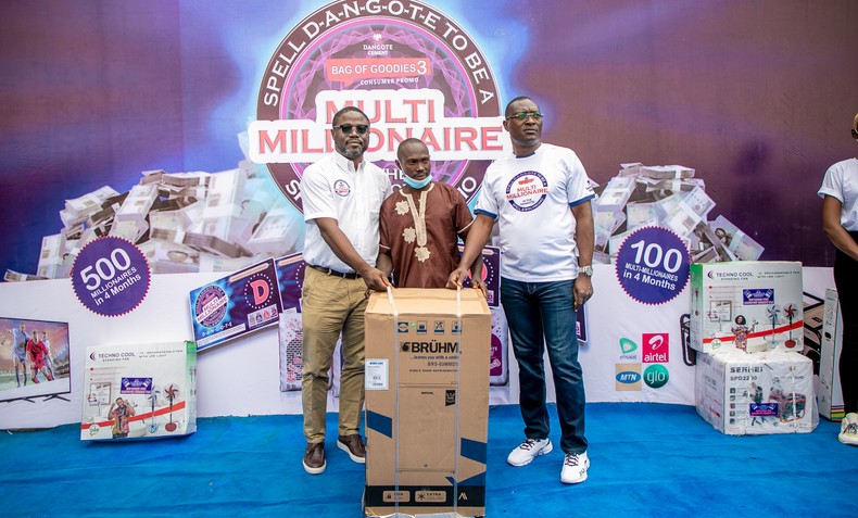 Presentation of refrigerator to a winner by Dangote team. 