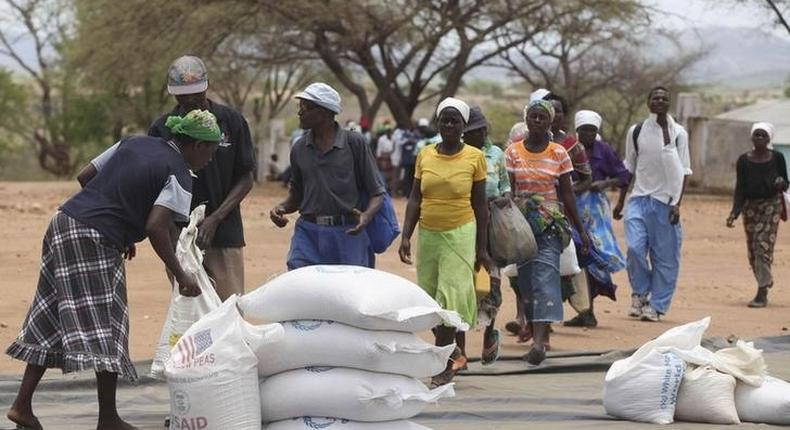 Zimbabweans collect food aid from a distribution point in Mutawatawa, about 220km northeast of the capital Harare, in a file photo. REUTERS/Philimon Bulawayo