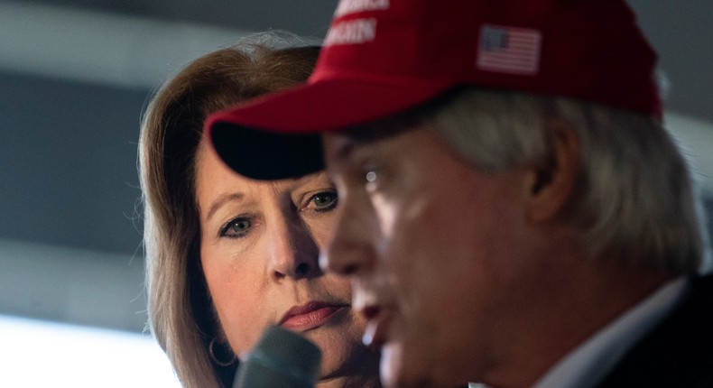 Sidney Powell stands next to Lin Wood as he speaks during a press conference on election results in Georgia.