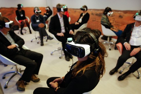 Participants attend the 'Collisions. A Virtual Reality World Premiere' event at the annual meeting o