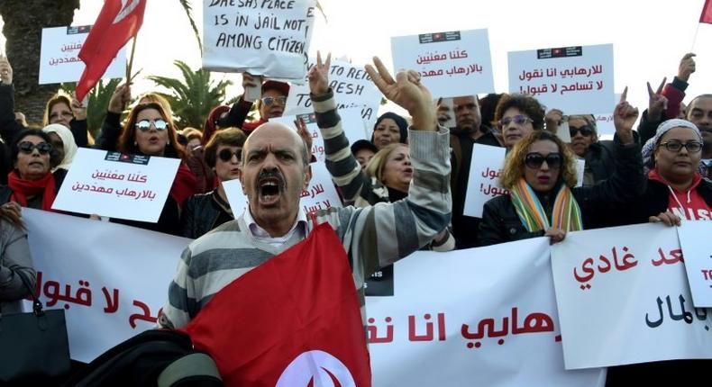 Tunisians demonstrate outside parliament in Tunis on December 24, against allowing Tunisians who joined the ranks of jihadist groups to return to the country