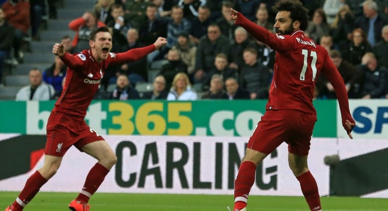 Liverpool's Egyptian midfielder Mohamed Salah (R) celebrates with Liverpool's Scottish defender Andrew Robertson (L) after scoring their second goal during the English Premier League football match between Newcastle United and Liverpool at St James' Park in Newcastle-upon-Tyne, north east England on May 4, 2019.