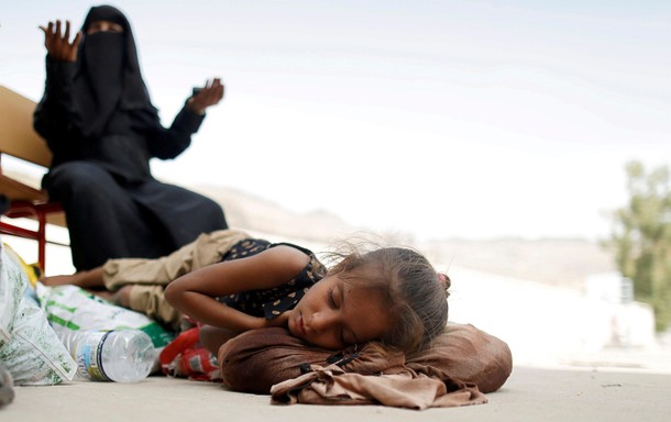 Woman displaced by the fighting in the Red Sea port city of Hodeidah reacts as she waits to be regis