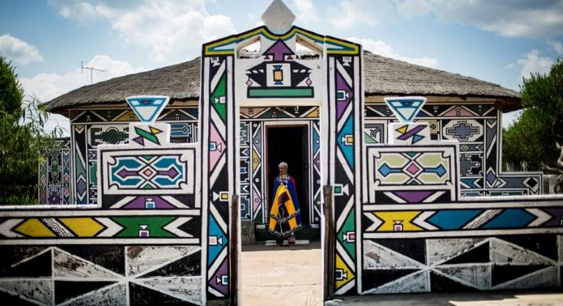 South African artist Esther Mahlangu, 81, whose colourful geometric works are exhibited around the world, stands outside her home in Mpumalanga