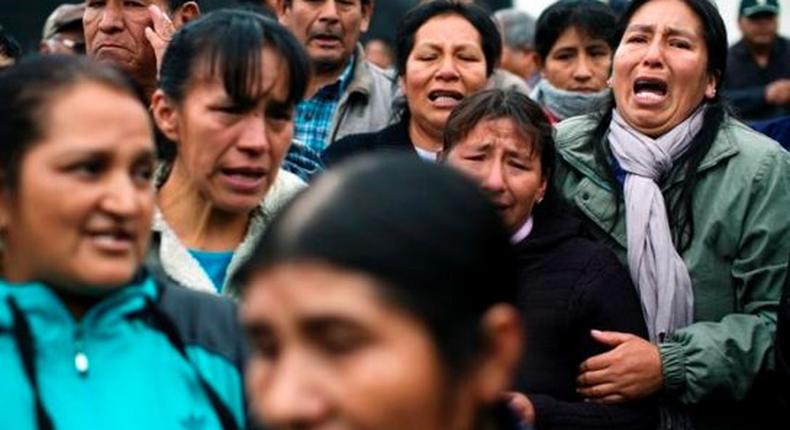 Relatives of 71 people massacred in 1985 by a military patrol in the Andean city of Accomarca, chant slogans asking for justice, outside a court in Lima, Peru, Wednesday, Aug. 31, 2016. 