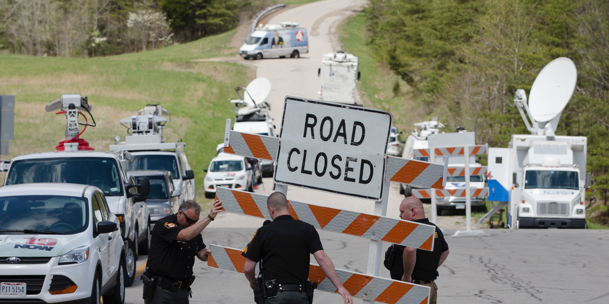 Authorities set up road blocks at the intersection of Union Hill Road and Route 32 at the perimeter of a crime scene on April 22 in Pike County, Ohio.
