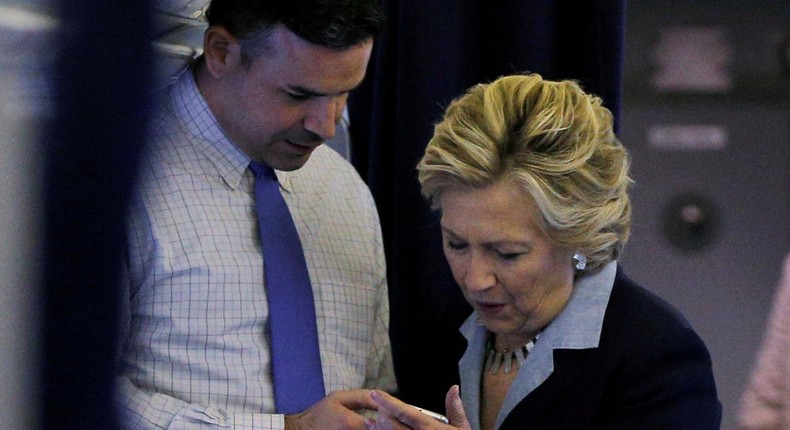 Hillary Clinton aboard her campaign plane with Brian Fallon in 2016.