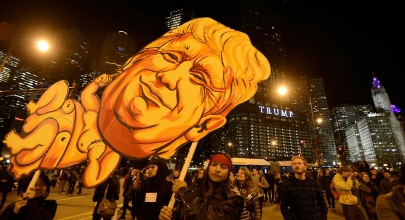 Demonstrators take part in a protest near Trump Tower in Chicago on November 9, 2016