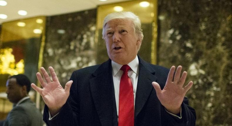 US President-elect Donald Trump stops to talk to the media in the lobby of Trump Tower on December 6, 2016 in New York