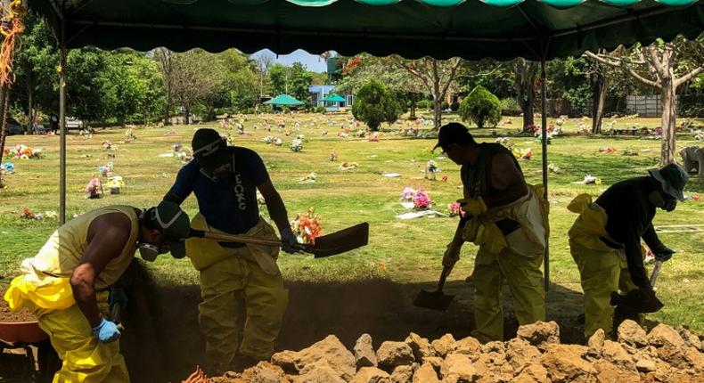 Men dig a grave at a cemetery in the Nicaraguan capital Managua