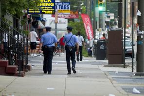Philadelphia Police officers patrol a street.