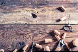 Corks from wine and opener on wooden table