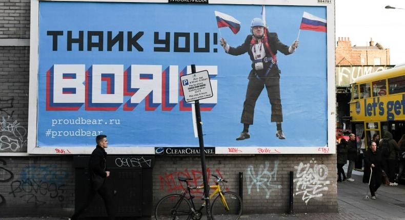 A Brexit-themed billboard depicting Britain's former foreign secretary Boris Johnson waving Russian national flags reading Thank you Boris