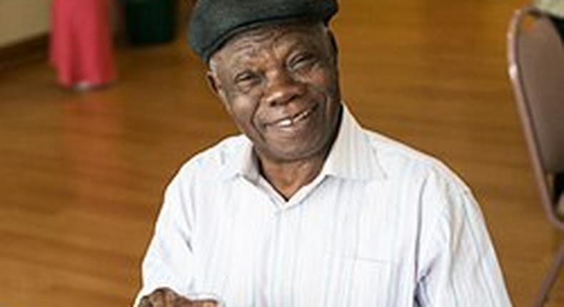 Older African American man making healthy eating choices for his diet with a glass of milk.